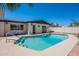 A backyard pool with a patio, surrounded by a block fence for privacy at 2446 E Hale St, Mesa, AZ 85213