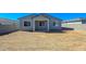 Home's backyard features a covered patio, block fence, and desert landscaping at 24552 W Hilton Ave, Buckeye, AZ 85326