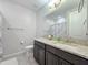 Bathroom featuring a granite countertop, dark cabinetry, and tiled flooring at 24552 W Hilton Ave, Buckeye, AZ 85326