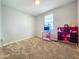Spacious bedroom with bright pink shelving, a window, and soft carpeting at 24552 W Hilton Ave, Buckeye, AZ 85326
