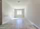 Bright bedroom features neutral walls, tile floor, and a window offering natural light at 24552 W Hilton Ave, Buckeye, AZ 85326