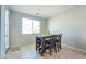 Bright dining area with modern table set, natural light, and neutral paint at 24552 W Hilton Ave, Buckeye, AZ 85326