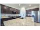 Modern kitchen featuring an island with granite countertops and stainless steel appliances at 24552 W Hilton Ave, Buckeye, AZ 85326