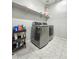 Modern laundry room featuring a front-loading washer and dryer set at 24552 W Hilton Ave, Buckeye, AZ 85326