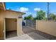 Backyard view featuring a garage and gate, complemented by gravel landscaping and a clear sky at 2601 N 51St St, Phoenix, AZ 85008