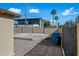 Backyard showcasing a concrete patio, rock landscaping, a modern home across the fence, and clear skies at 2601 N 51St St, Phoenix, AZ 85008