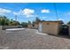 Landscaped backyard with gravel and concrete patio plus side view of the home's exterior on a sunny day at 2601 N 51St St, Phoenix, AZ 85008
