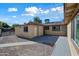 View of the backyard with gravel, walkway, concrete patio, and the exterior of the house on a sunny day at 2601 N 51St St, Phoenix, AZ 85008