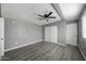Bright bedroom featuring wood-look floors, ceiling fan and closet with sliding doors at 2601 N 51St St, Phoenix, AZ 85008