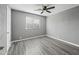 Bright bedroom with wood-look floors, ceiling fan, and window at 2601 N 51St St, Phoenix, AZ 85008