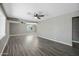The open living room boasts sleek gray flooring and ample space, complemented by a contemporary ceiling fan at 2601 N 51St St, Phoenix, AZ 85008