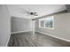 Well-lit living room featuring stylish gray flooring, a modern ceiling fan, and a view into the hallway at 2601 N 51St St, Phoenix, AZ 85008