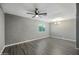Living room with gray walls and gray flooring, modern ceiling fan, and natural light from a window at 2601 N 51St St, Phoenix, AZ 85008