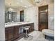 Bright bathroom showcasing dual vanities, chandelier lighting, and a mirrored wall, exuding spa-like luxury at 2822 E Constance Way, Phoenix, AZ 85042