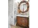 Stylish bathroom with a carved wood vanity, marble countertop, and decorative mirror at 2822 E Constance Way, Phoenix, AZ 85042