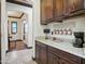 Charming coffee bar features granite countertops, custom cabinets, and decorative mugs, perfect for coffee lovers at 2822 E Constance Way, Phoenix, AZ 85042