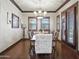 Formal dining room featuring hardwood floors, a chandelier, and large windows for natural light at 2822 E Constance Way, Phoenix, AZ 85042