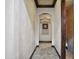 Elegant hallway featuring textured walls, arched doorway, and tasteful decor, with access to a bathroom at 2822 E Constance Way, Phoenix, AZ 85042