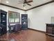 Elegant home office featuring rich wood flooring, a ceiling fan, and dark wood trim and cabinets at 2822 E Constance Way, Phoenix, AZ 85042