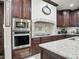 Gourmet kitchen showcasing stainless steel appliances and custom cabinets, perfect for cooking enthusiasts at 2822 E Constance Way, Phoenix, AZ 85042