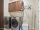 Well-equipped laundry room with modern washer and dryer and functional storage space at 2822 E Constance Way, Phoenix, AZ 85042