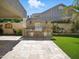 Outdoor kitchen featuring built-in barbecue, storage, and stone accents overlooking a grassy lawn at 2822 E Constance Way, Phoenix, AZ 85042