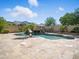 Inviting pool area with waterfall feature, surrounded by palm trees and travertine tile at 2822 E Constance Way, Phoenix, AZ 85042