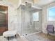 Modern bathroom featuring an enclosed glass shower and marble wall tiles, perfect for relaxation at 2822 E Constance Way, Phoenix, AZ 85042