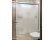 Modern bathroom with glass sliding shower door, tiled walls, and sleek fixtures at 2822 E Constance Way, Phoenix, AZ 85042