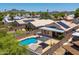 Aerial view of residential backyard with a sparkling pool, patio, and lush greenery at 316 W Kelton Ln, Phoenix, AZ 85023