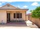 View of the covered back patio with a patterned rug and view of a tree at 316 W Kelton Ln, Phoenix, AZ 85023