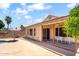 Home's beautiful backyard featuring a covered patio, palm tree, and an umbrella table set at 316 W Kelton Ln, Phoenix, AZ 85023