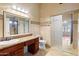 Bright bathroom with large vanity, granite countertop and glass enclosed shower at 316 W Kelton Ln, Phoenix, AZ 85023