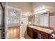 Bathroom featuring a vanity with granite countertop and access to bedroom at 316 W Kelton Ln, Phoenix, AZ 85023