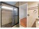 Bathroom featuring a glass-enclosed shower, a light tiled finish, and modern fixtures at 316 W Kelton Ln, Phoenix, AZ 85023