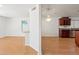 Open-concept dining area with adjacent kitchen, hardwood floors and white painted walls at 316 W Kelton Ln, Phoenix, AZ 85023