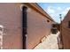 Exterior view of the side of the house showing an outdoor shower and gravel landscaping at 316 W Kelton Ln, Phoenix, AZ 85023