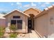 Front exterior of a home featuring desert landscaping, tile roof, and a decorative security door at 316 W Kelton Ln, Phoenix, AZ 85023