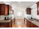 Open kitchen with granite countertops, stainless appliances, and chandelier-lit breakfast nook at 316 W Kelton Ln, Phoenix, AZ 85023