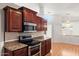 Kitchen with stainless steel appliances, granite countertops, and dark wood cabinetry at 316 W Kelton Ln, Phoenix, AZ 85023