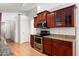 Kitchen featuring stainless steel appliances, granite countertops, and dark wood cabinetry at 316 W Kelton Ln, Phoenix, AZ 85023