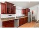 Kitchen showcasing stainless steel appliances, granite countertops, and dark wood cabinetry at 316 W Kelton Ln, Phoenix, AZ 85023