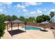 Home's beautiful pool and gazebo, surrounded by greenery and a block fence for privacy at 316 W Kelton Ln, Phoenix, AZ 85023