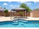 A relaxing pool view with a gazebo, trees, and a shed in a block-fenced yard at 316 W Kelton Ln, Phoenix, AZ 85023