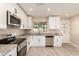 Bright kitchen with stainless appliances, granite countertops, and modern white cabinetry at 3209 N 20Th Pl, Phoenix, AZ 85016