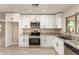 Updated kitchen featuring granite counters, white cabinetry and stainless steel appliances at 3209 N 20Th Pl, Phoenix, AZ 85016