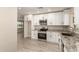 This kitchen features white cabinets, stainless steel appliances, and granite countertops at 3209 N 20Th Pl, Phoenix, AZ 85016