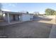 Spacious backyard with a covered patio area and large gravel area at 3418 W Roma Ave, Phoenix, AZ 85017
