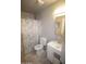 Small bathroom featuring a shower with seashell curtain, white sink, and toilet at 3418 W Roma Ave, Phoenix, AZ 85017