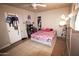 Bedroom with tile flooring, ceiling fan and adjacent closet space at 3418 W Roma Ave, Phoenix, AZ 85017